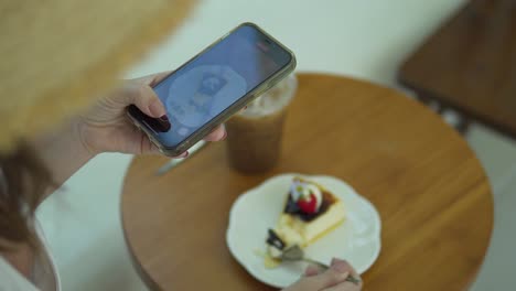 A-top-angel-shot-of-a-young-girl-using-photography-of-smartphone-of-food-on-mobile-camera-display-while-shooting