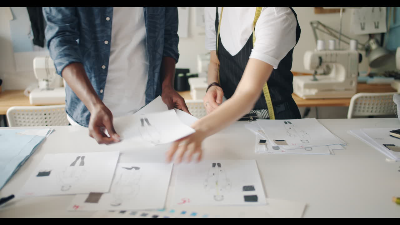 Fashion Designers Working on Sketches