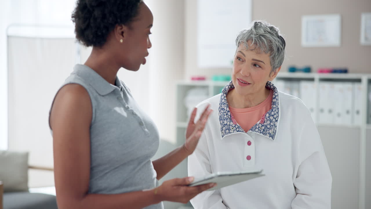 Doctor consulting with senior female patient
