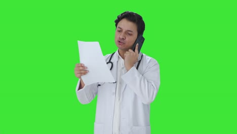 Angry-Indian-doctor-explaining-medical-report-on-call-Green-screen