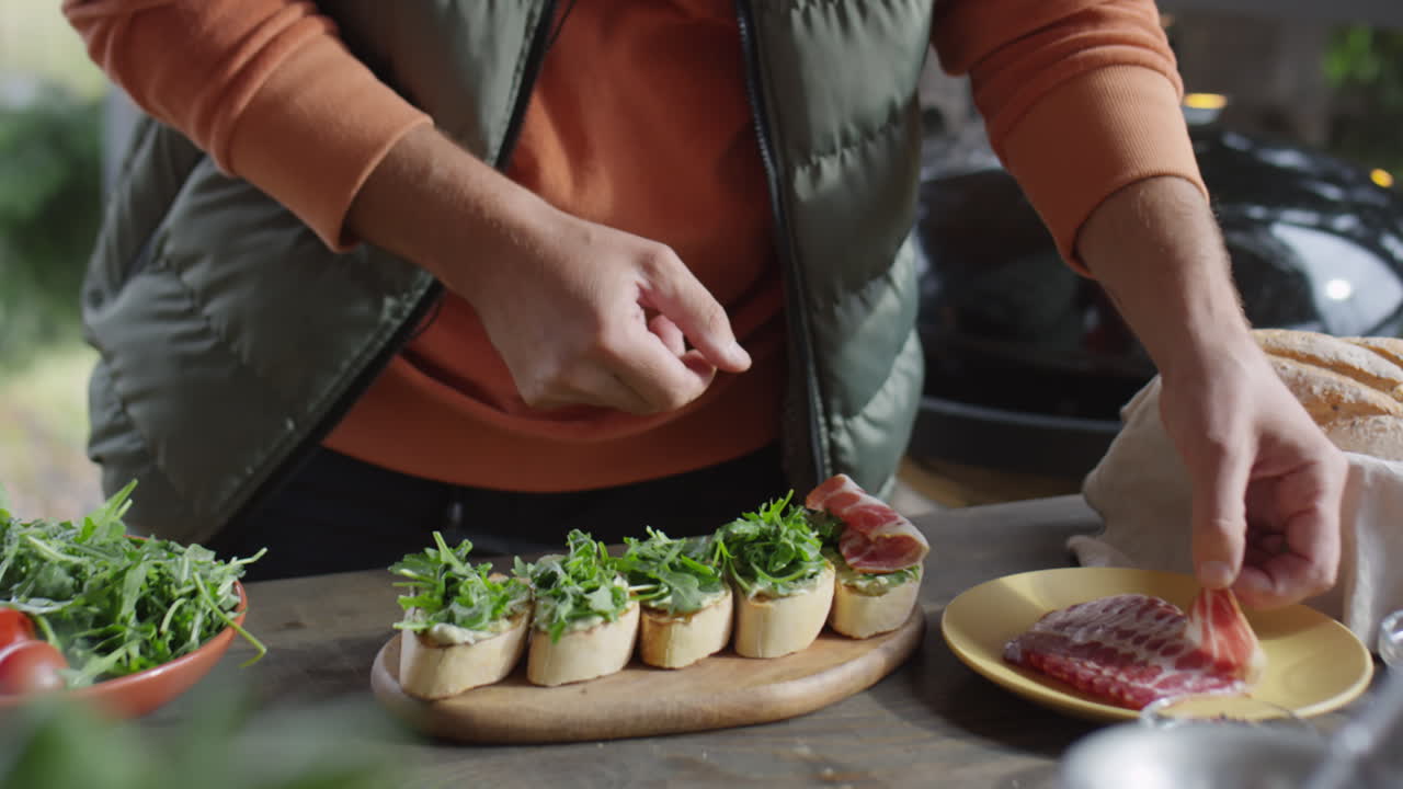 Chef Cooking Bruschettas with Bacon and Arugula