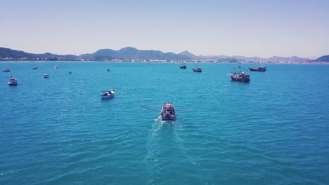 toma de vista trasera aérea de 4k siguiendo un barco de pesca apuntado en la parte posterior