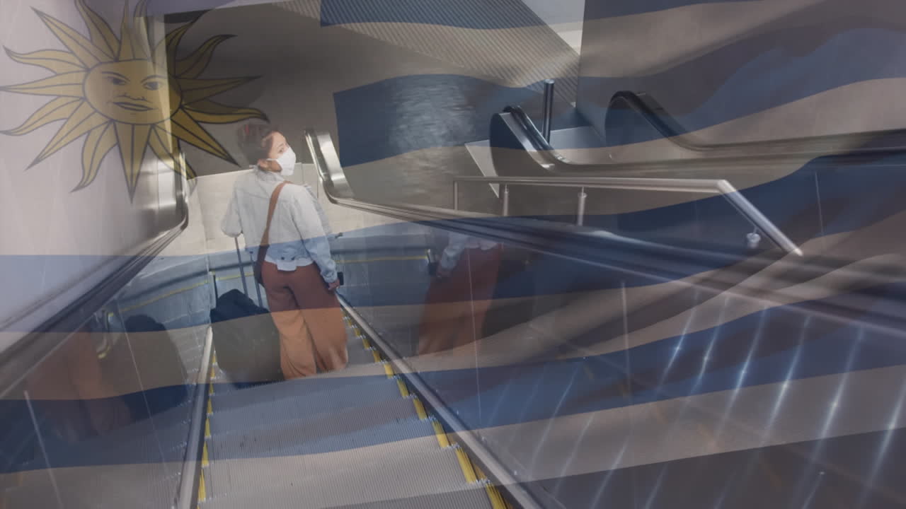 bandera uruguaya ondeando contra una mujer con máscara facial en la escalera mecánica