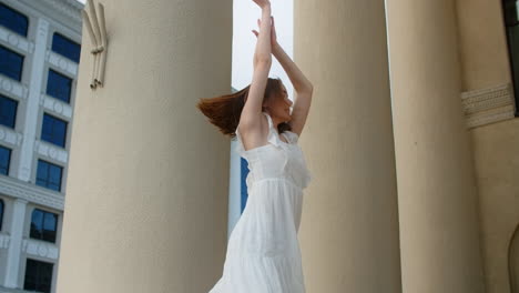 woman dancing in front of columns