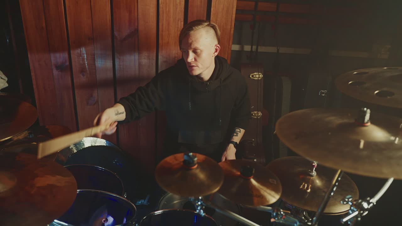 Drummer playing drums in a recording studio