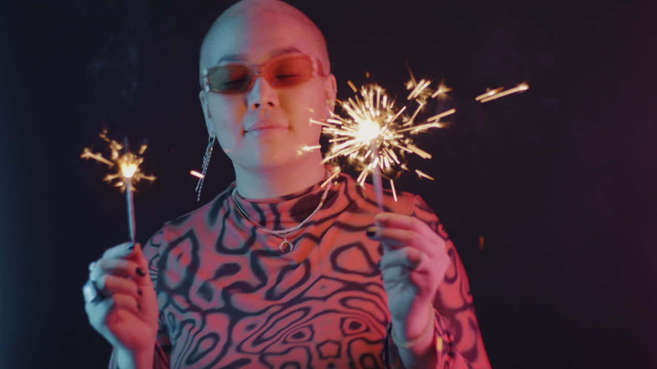 Stylish Woman with Sparkler in Neon Light