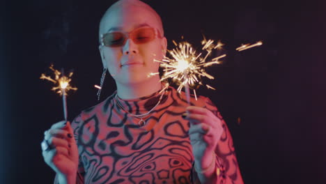stylish woman with sparkler in neon light