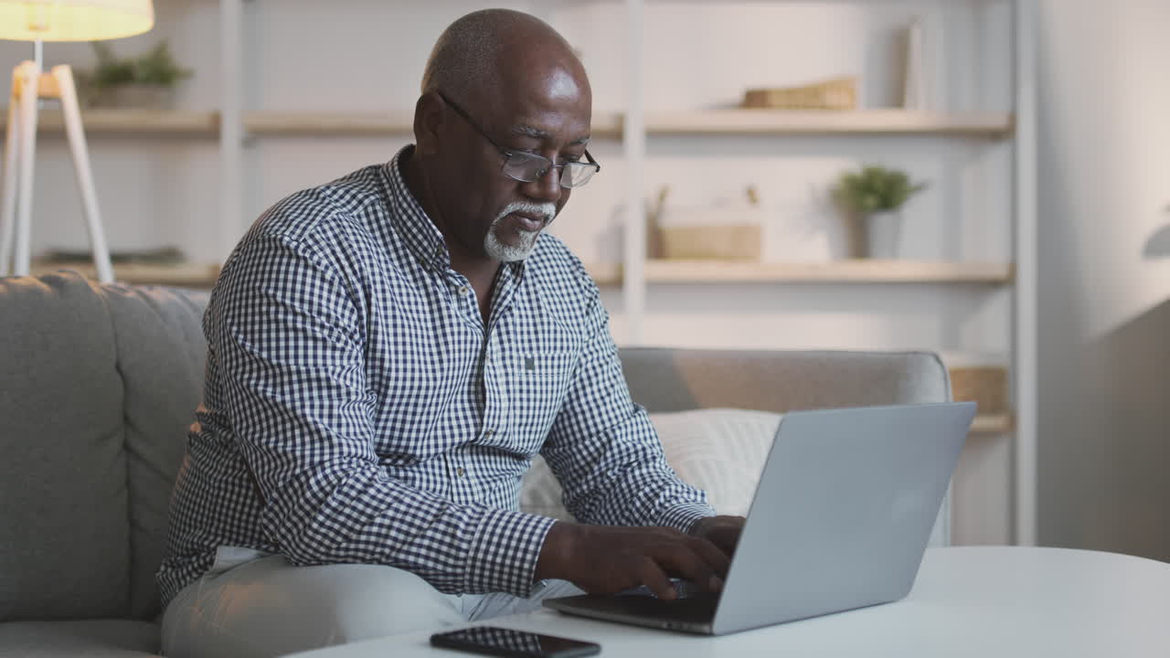 Older Man Using Laptop at Home