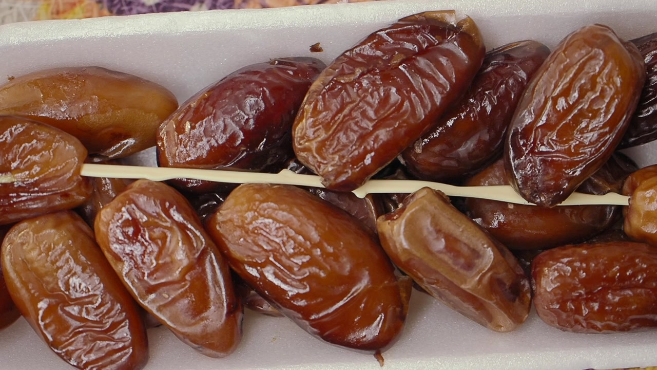 Sweet Brown Dates Arranged in a White Tray