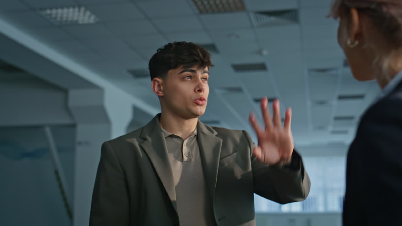 Couple engineers examining construction site closeup. Two people shaking hands