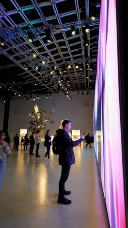 visitors interacting with a large led art installation at a modern exhibition