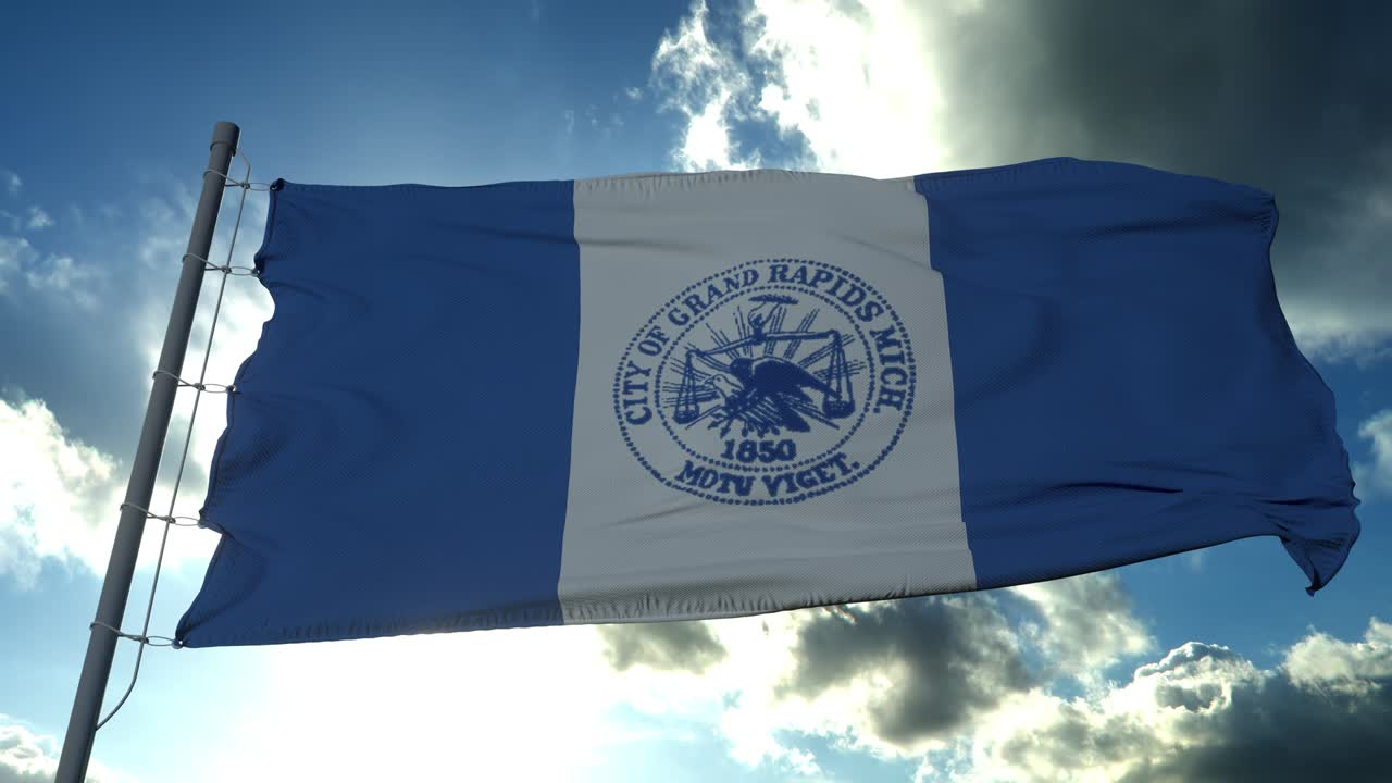 bandera de la ciudad de grand rapids, ciudad de michigan, estados unidos de américa, ondeando al viento en el cielo azul