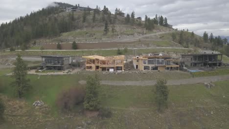 An-aerial-Drone-shot-of-a-house-overlooking-a-lake-being-constructed