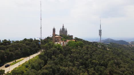 aerial drone 4k footage of tibidabo in barcelona, showcasing the majestic mountain, iconic amusement park, and panoramic views