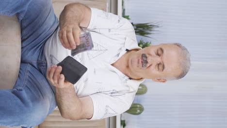 Vertical-video-of-The-rich-old-man-with-money-is-happy.