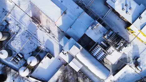 Overhead-aerial-view-of-an-industrial-building-in-winter,-Silute,-Lithuania,-Germany