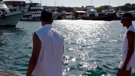 Men walking on a dock at a harbor