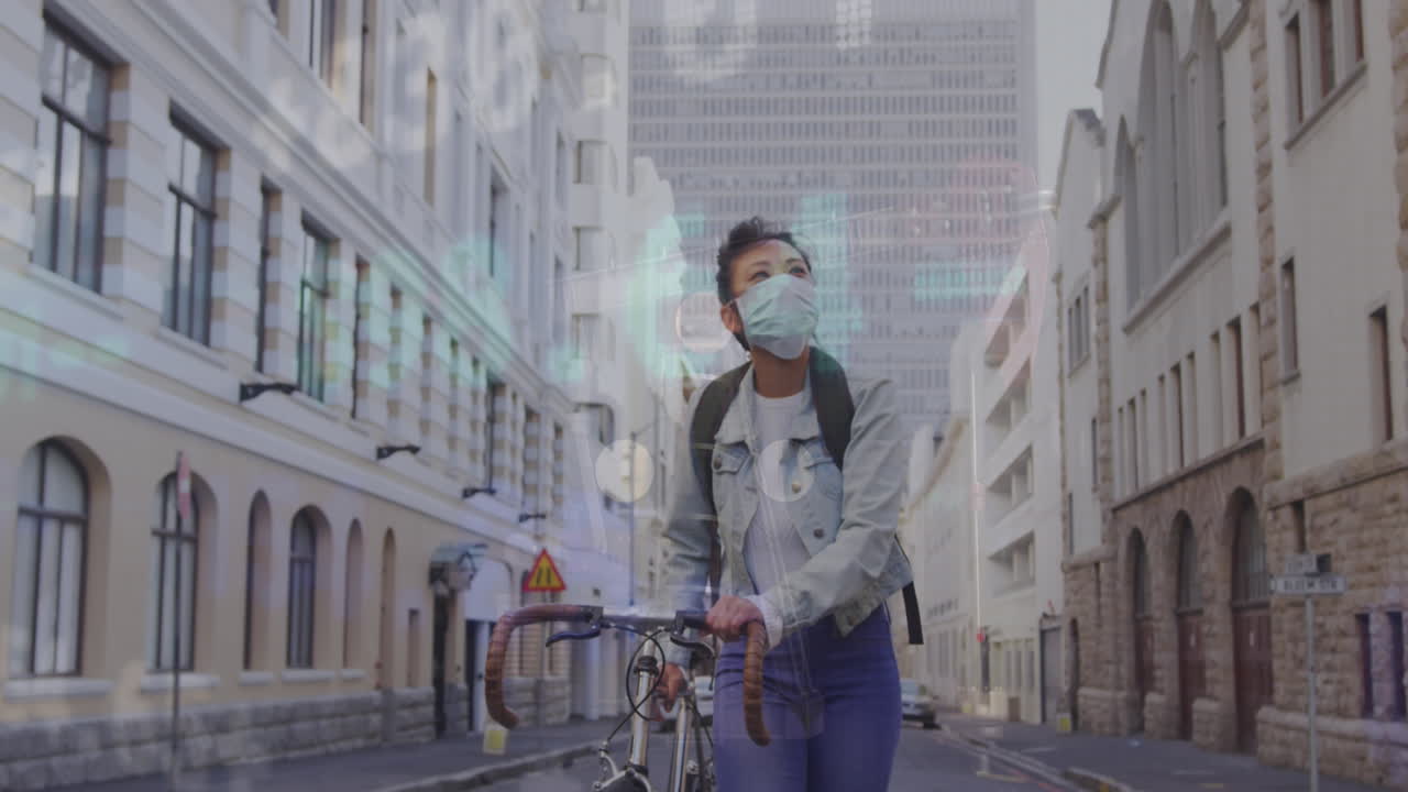 Animation of stock market data processing over asian woman wearing face mask with bicycle walking
