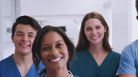 portrait of smiling multi-cultural medical team standing in hospital corridor