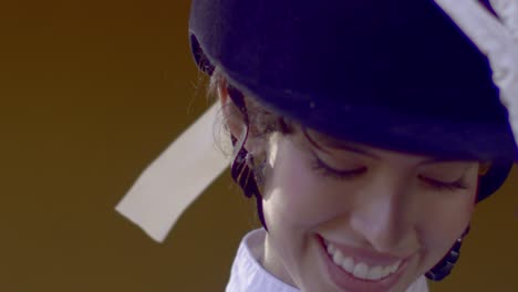 A-close-up-shot-captures-the-beautiful-smile-of-an-elegant-equestrian-woman-as-she-prepares-for-her-ride