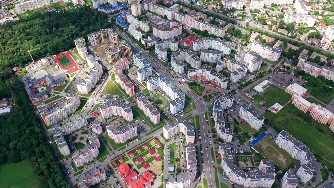 Urban background. Modern city with skyscrapers and traffic with cars. View from above on high-rise residential buildings. Aerial view.