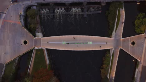 aerial top-down view of galway's salmon weir pedestrian and cycle bridge during twilight