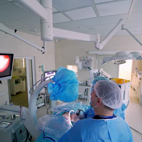 surgery by specialists. modern medical equipment in the operating room. professional doctors and assistant operate the patient in hospital. view from above.
