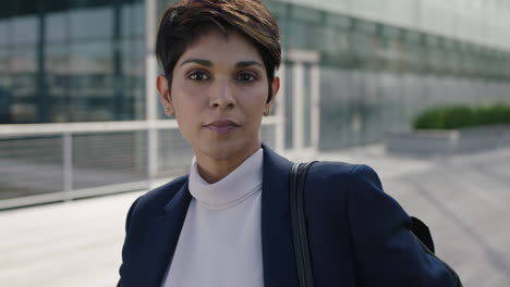 portrait of attractive professional business woman commuter leaving work looking serious