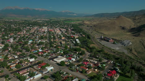 aerial cinematic drone mid summer downtown salida s colorado near buena vista on arkansas river riverside park scout surfing wave biking hiking rafting rocky mountain up high forward movement