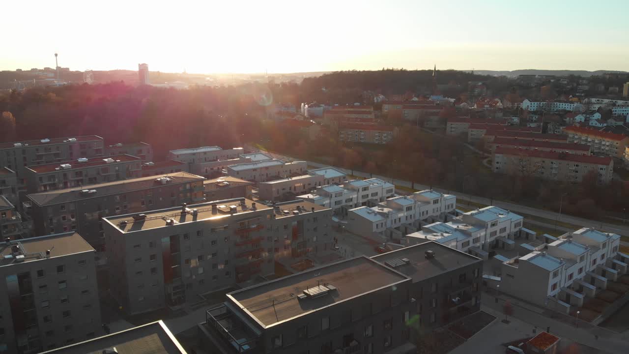 Aerial footage of newly developed apartements in suburb Orgryte torp with Gothenburg skyline in the background at sunset