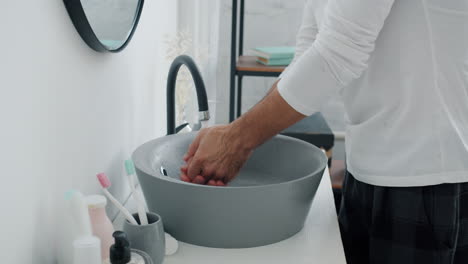 man washing face and styling hair