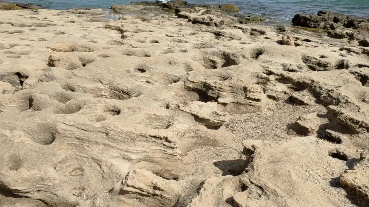 Close-up of rocky stretch along the sea with geological formations. Spain