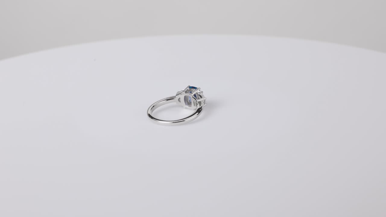 A sparkling sapphire ring displayed on a clean white background