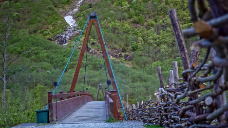 tourists crossing the wooden bridge in the viking valley in norway