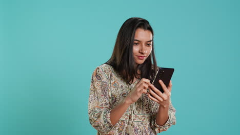 Woman-scrolling-on-phone-touchscreen-to-check-social-media-feed,-amazed-by-photo