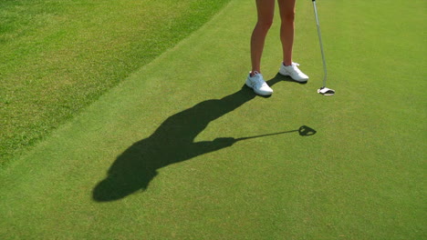 Golfer-putting-ball-in-green-golf-course-in-the-rocky-mountains-of-Banff-and-Kananaskis-of-Alberta,-Canada