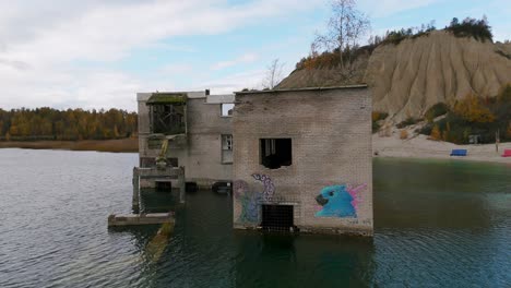 Abandoned Brick Building in Autumn Lake