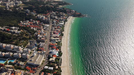 flying over praia bombinhas beach and blue sea coastline, brazil