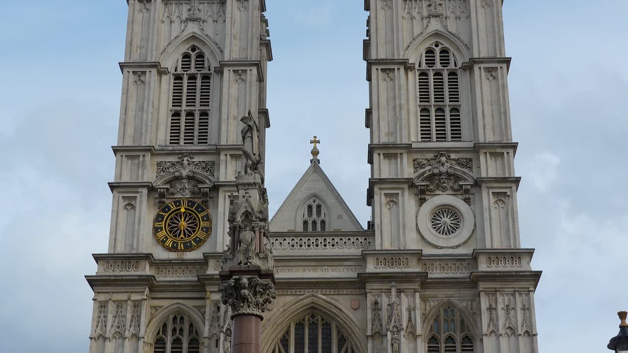 Abbazia di Westminster a Londra con una vista frontale delle torri gemelle, dell'orologio e dei dettagli della facciata. Scena diurna che mostra l'architettura gotica contro il cielo