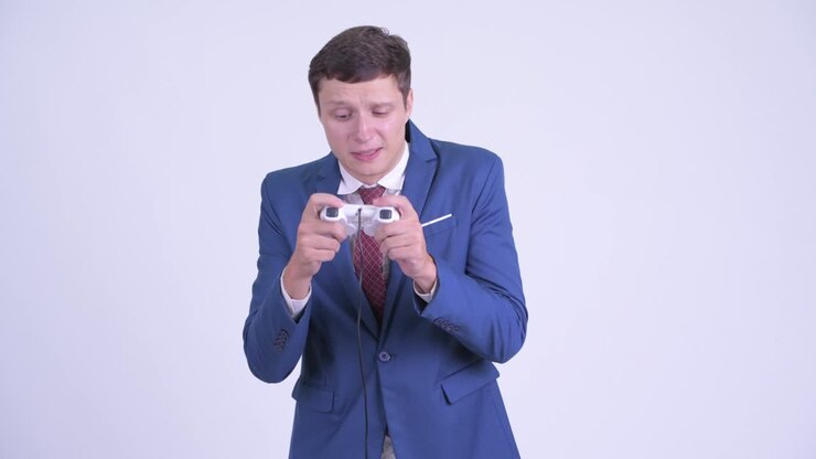 Young handsome businessman playing games