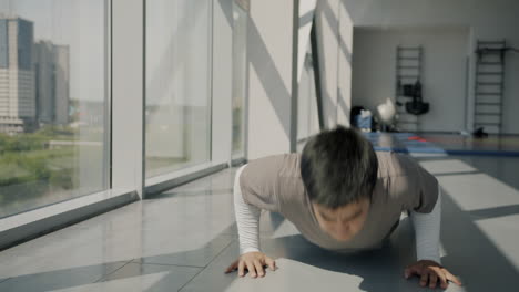 man doing push-ups in a gym