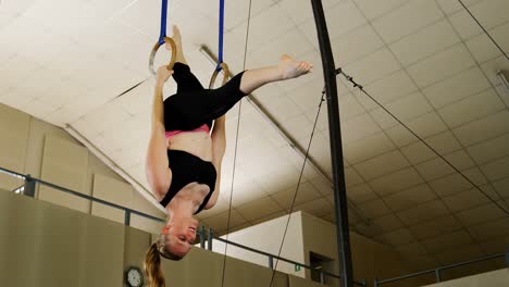 gymnast practicing with ring row