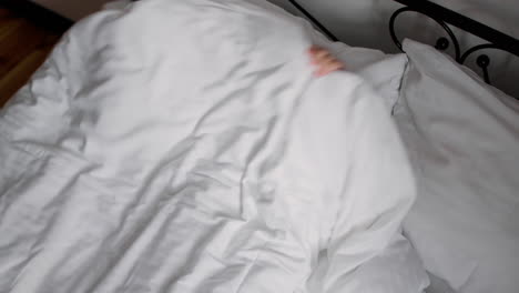 girl smiling while lying in bed