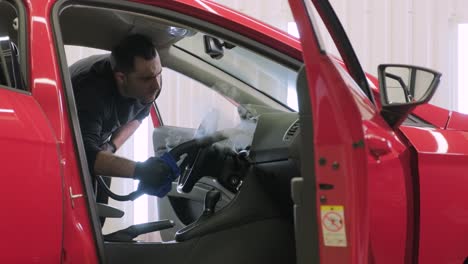 professional car cleaning. сar wash. interior detailing. dry clean and detail a car interior. deep seats cleaning. wiping foam in car wash. cleaning the car panel from dust. a vacuum cleaner