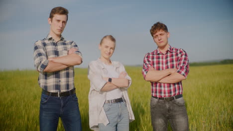 three people in a wheat field