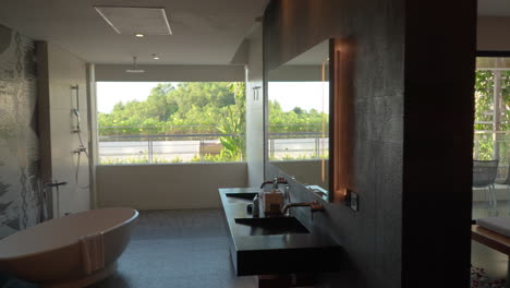 luxury hotel room with bathtub and garden view in uluwatu, bali, indonesia. sideways shot