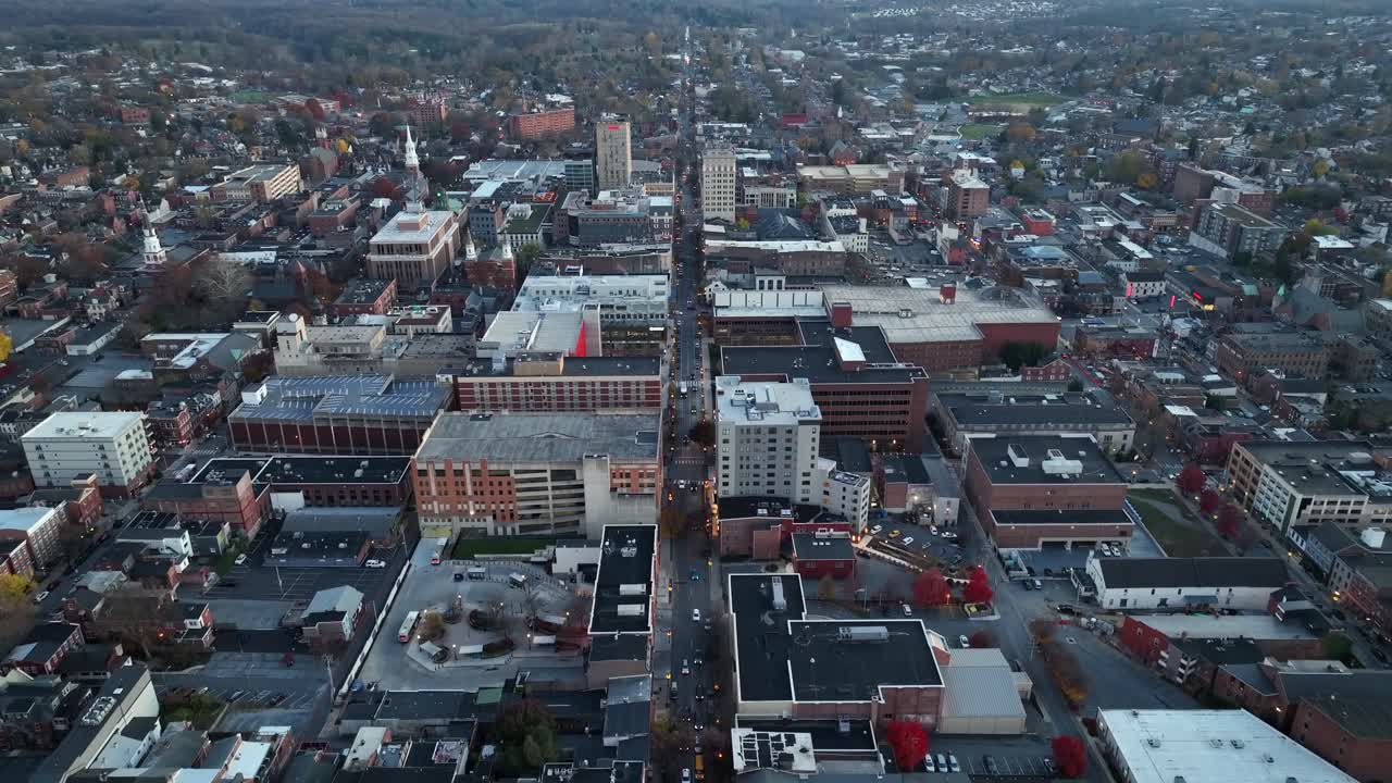 ciudad histórica durante el día nublado en la temporada de otoño. tráfico en la carretera principal del centro de la ciudad. edificios de oficinas y área residencial. drone en aumento disparo ancho.