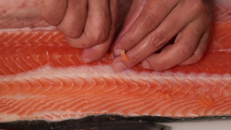 Deboning-fresh-salmon-for-a-delicious-Sushi-snack---close-up-slowmo