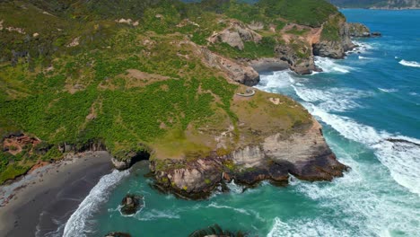 Aerial-view-establishing-mountains-with-nalcas-and-the-time-pier-at-tepuhueico-park-in-Cucao,-Chiloe-Chile