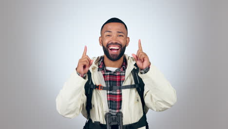 hiking, travel and face of man in studio pointing